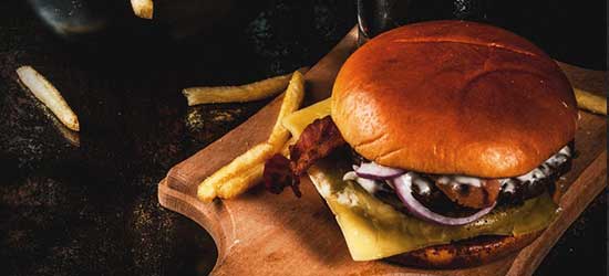 Cheese burger with bacon, onion and fries served at Farm to Fork in Ringgold, GA.